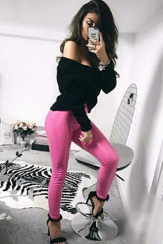 Cara in a black top and pink leggings