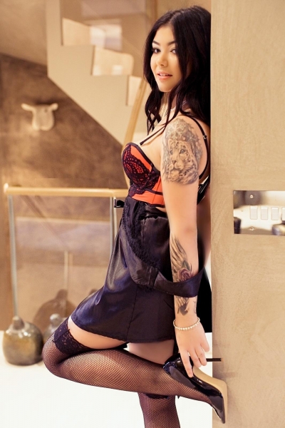 Dana showing off her tattoos as she pulls down her top