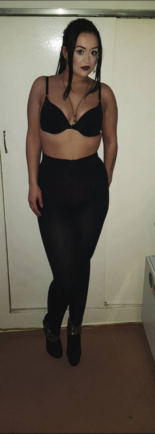 Katilynn wearing a black bra and black leggings