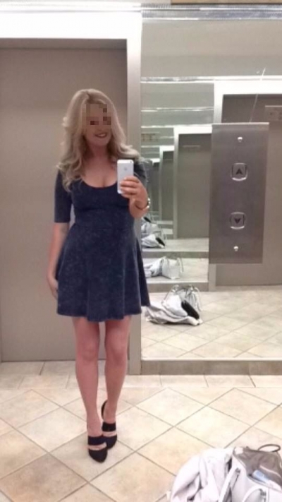 Tiffany stood in blue dress and black heels.