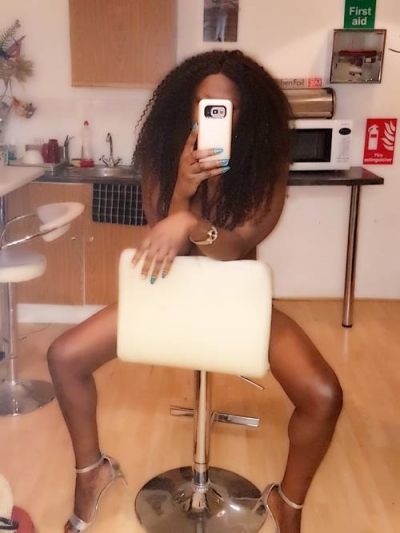 Shantay taking a selfie on a chair naked
