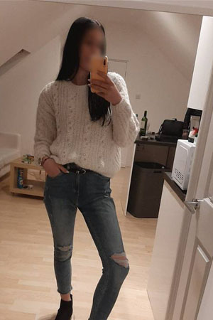 Jessica taking selfie in white jumper